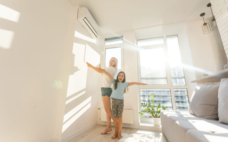 mother and daughter hangs a large photo canvas at home mother and daughter hangs a large photo canvas at home